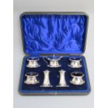 LARGE SEVEN PIECE CONDIMENT SET WITH BLUE GLASS LINERS, BY R.F. MOSLEY & Co., SHEFFIELD 1919/21,