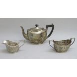 EDWARDIAN EMBOSSED SILVER TEASET COMPRISING TEAPOT, SUGAR BASIN AND CREAM JUG BY JONES & CROMPTON,