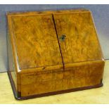 VICTORIAN WALNUT STATIONERY BOX WITH A HINGED TOP AND SLOPING FRONT WITH TWO HINGED DOORS DISCLOSING