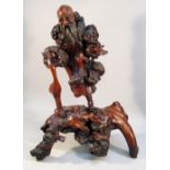 CHINESE ROOT WOOD CARVING OF A MAN WITH OPEN ARMS AND A BIRD BENEATH (33cm x 24.5cm). PROVENANCE: