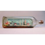 OLD SHIP IN A BOTTLE WITH COASTAL VILLAGE SCENE, A THREE MASTED SHIP AND LIGHTHOUSE (L: 26cm)