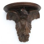 CONTINENTAL CARVED WALNUT SEMI-CIRCULAR WALL BRACKET OF AN EAGLE WITH LATER PLASTER HEAD (25cm x