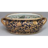 CHINESE STYLE DOUBLE HANDLED PORCELAIN FOOT BOWL WITH COBALT BLUE AND GILT FLORAL EXTERIOR