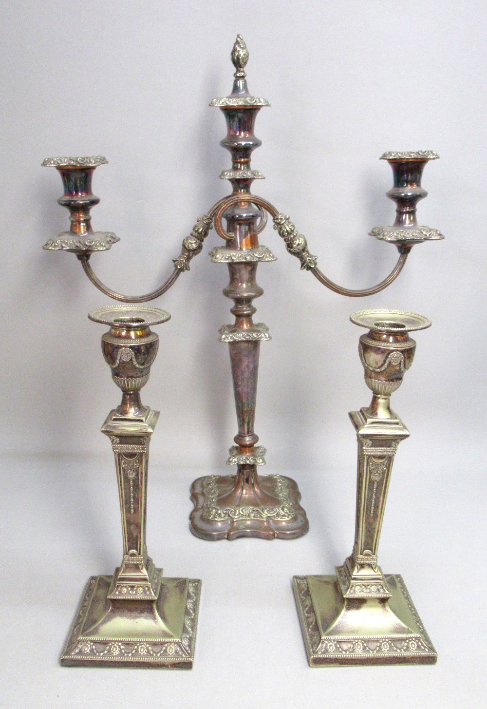 PAIR OF EDWARDIAN SILVER PLATED ADAM STYLE CANDLESTICKS BY HENRY EYRE & Co. (H: 28.5cm), THREE LIGHT
