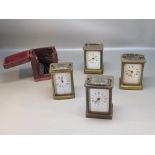 THREE FRENCH BRASS CARRIAGE TIMEPIECES AND AN AMERICAN TIMEPIECE, FOUR KEYS AND A CARRYING CASE [9]