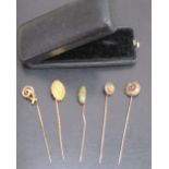 FIVE LATE VICTORIAN YELLOW METAL AND GOLD GEM-SET STICKPINS, ONE DESIGNED AS A FLORAL PANEL WITH A