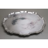 HEAVY GUAGE SILVER SHAPED OVAL SALVER WITH A PIECRUST RIM, ON FOUR SCROLL LEGS, HOOF FEET, BY C J