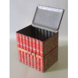 HUNTLEY AND PALMERS BISCUIT TIN IN THE FORM OF EIGHT RED AND GILT BOOKS WITH CENTRAL STRAP (16cm