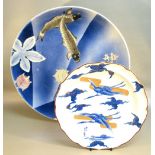 JAPANESE PORCELAIN SAUCERDISH DECORATED WITH TWO FISH AND A FLOWERING TREE ON A BLUE STRIPED GROUND,