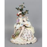 GOOD MEISSEN GROUP OF A YOUNG MAN AND WOMAN, A LAMB ON HIS LAP AND SITTING ON A TREE STUMP {H: