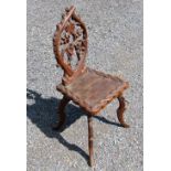 EARLY 20th CENTURY MID EUROPEAN CARVED ELM CHAIR WITH A PIERCED ACORN AND LEAF OVOLO BACK, CHECKER