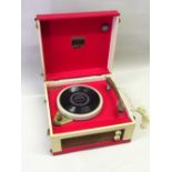 DANSETTE JUNIOR DELUXE RECORD PLAYER WITH A FOUR SPEED DECK, IN A RED AND CREAM CASE, BY J & A