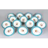 SET OF 14 FRENCH PORCELAIN PLATES, WITH BLUE BORDERS, THE CENTRES PAINTED WITH FLOWERS (DIA: 21.