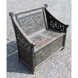 EARLY 20th CENTURY ORIENTAL EBONIZED CARVED WOOD BENCH SEAT WITH A BIRD AND FLORAL PANELLED SCROLL