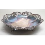 GEORGE V SILVER OCTAGONAL FRUIT BOWL WITH PIERCED FOLIATE DECORATION AND SHAPED RIM, ON THREE LOW