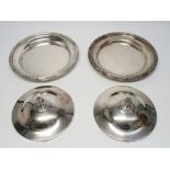 A PAIR OF SILVER CIRCULAR DISHES EACH WITH A REEDED FOLIATE RIM, CRESTED AND INSCRIBED DOMED