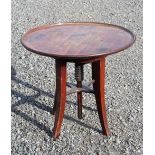 A MAHOGANY CIRCULAR TOP REVOLVING TABLE OF ADJUSTABLE HEIGHT SUPPORTED BY A TURNED WOODEN SCREW ON