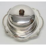 SILVER CIRCULAR MUFFIN DISH WITH A SHAPED GADROONED BORDER, LINER AND DOMED COVER, BY GLADWIN