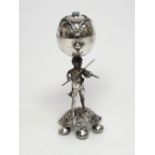 A DUTCH SILVER PEPPERETTE, IN THE FORM OF A PUTTO PLAYING THE VIOLIN WHILST BALANCING A BALL, SET