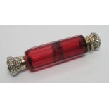 A VICTORIAN RUBY GLASS FLUTE-CUT DOUBLE PERFUME BOTTLE, WITH MOULDED SILVER TOPS, (L.10.5 CM)