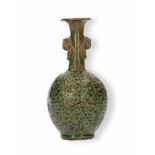 A terracotta bottle vase with grips in the shape of rings. The belly with a curly decor in thick