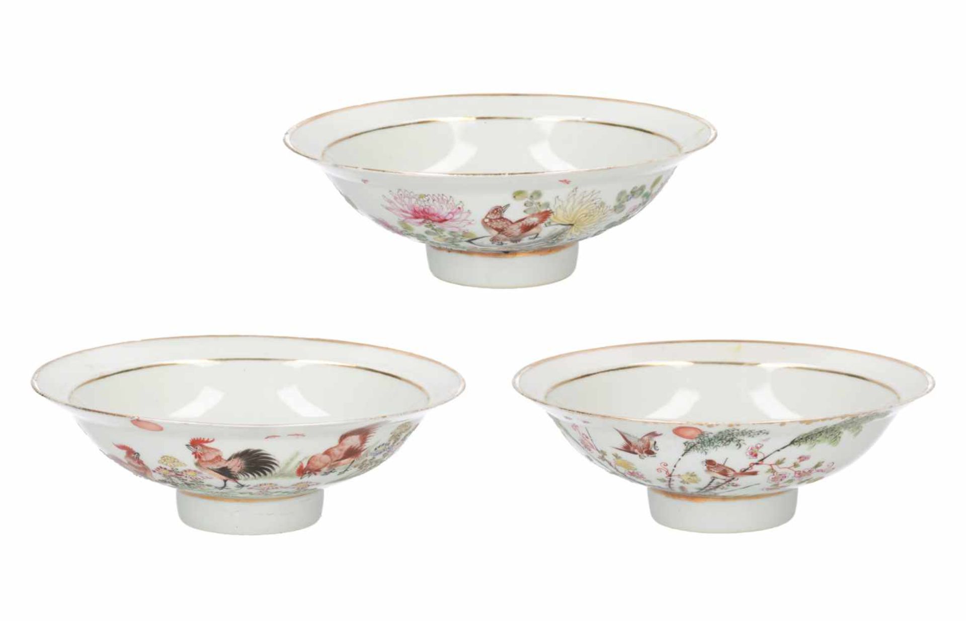 A lot of three polychrome porcelain bowls, decorated with flowers, birds and characters. Marked with