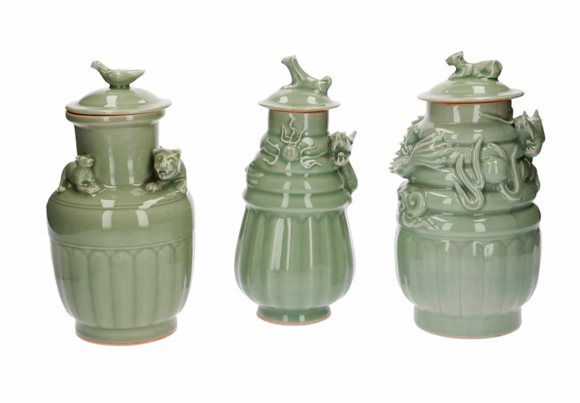 A lot of three celadon lidded vases, decorated with dragons and a tiger. All unmarked. China, 20th