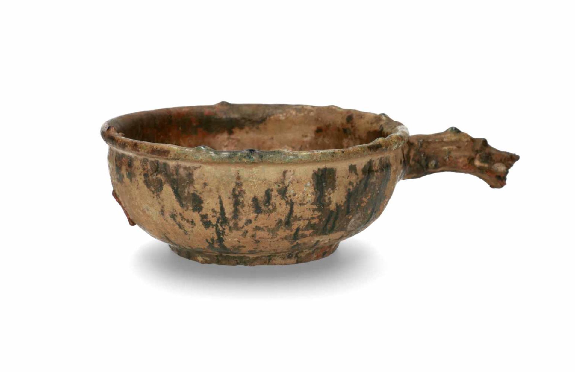 A green glazed ceramic bowl with dragon handle. Groove decorated wall. The dragon head with detailed