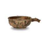 A green glazed ceramic bowl with dragon handle. Groove decorated wall. The dragon head with detailed