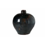 A round shaped black glazed jar with girded neck. The body with horizontal relief lines. China,