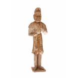 An earthenware unglazed sculpture of a male attendant, probably a musician. China, Tang. H. 30,5