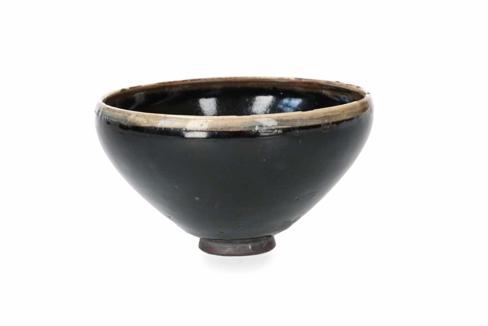 A black glazed bowl with cream glazed rim. China, Honan, Song. H. 7,5 cm. Diam. 14 cm. - Image 3 of 5