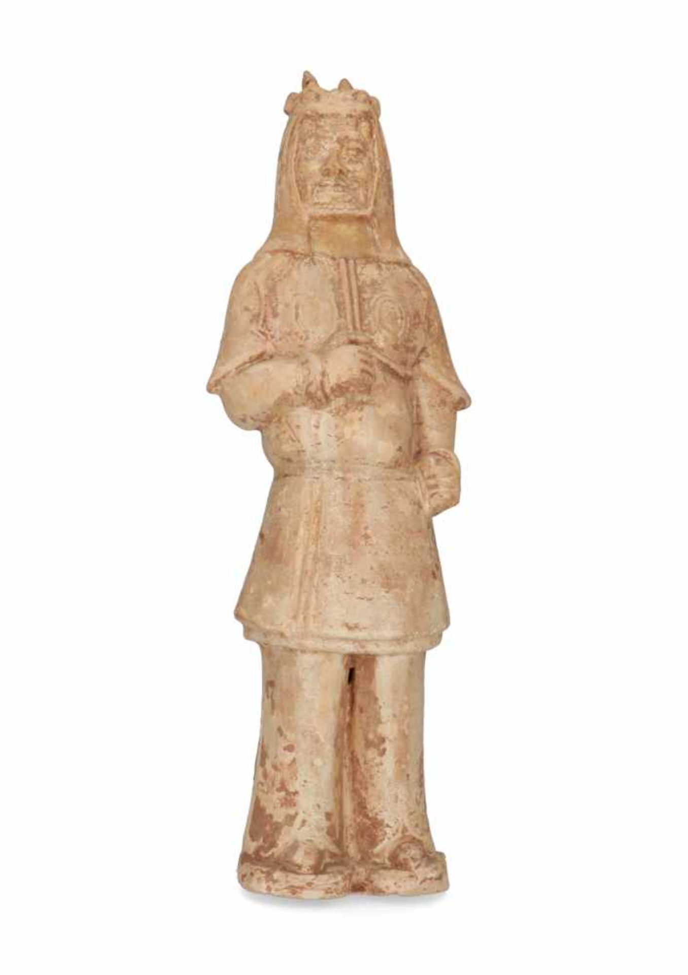 An earthenware standing warrior, his head covered with lion head. China, Tang. H. 41,5 cm.