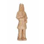 An earthenware standing warrior, his head covered with lion head. China, Tang. H. 41,5 cm.