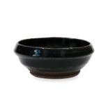A Cizhou bowl in a rare shape of narrowing rim. China, Honan, Song. H. 5,5 cm. Diam. 13,5 cm.