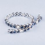 A DIAMOND AND SAPPHIRE BRACELET the six diamonds weighing approximately 1ct in total, colour K/L,