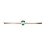 A TOURMALINE BAR BROOCH the 1.38ct oval bluish green tourmaline set to the centre of a 9k yellow