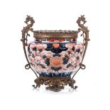 A JAPANESE GILT-METAL MOUNTED IMARI JAR, 19TH CENTURY the ribbed body profusely painted with large