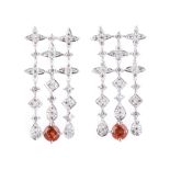 A PAIR OF DIAMOND AND MANDARIN GARNET PENDANT EARRINGS three rows of ﬁve pavé-set diamonds