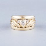 AN 18K YELLOW GOLD DRESS RING AND BANDS the centre pear shaped diamond weighing approximately 0.