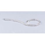 AN 18K WHITE GOLD AND DIAMOND TENNIS BRACELET the claw-set diamonds weighing approximately 6.