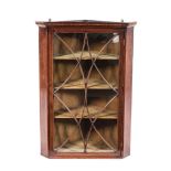 A GEORGE III MAHOGANY HANGING CORNER CABINET