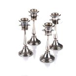 A SET OF FOUR PORTUGUESE SILVER CANDLESTICK HOLDERS each of typical from, loaded 13cm high (4)