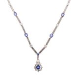 AN 18K WHITE GOLD, TANZANITE AND DIAMOND NECKPIECE the art deco style pendant suspended from a