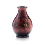 A WALTER MOORCROFT FLAMBÉ ‘CLEMATIS’ PATTERN VASE, CIRCA 1953 the ovoid form with clematis on a