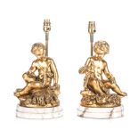 A PAIR OF GILDED METAL LAMPS, 19TH CENTURY each decorated with cherubs sitting on a bail of wheat,