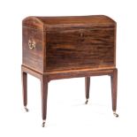 AN REGENCY MAHOGANY CELLARETTE ON STAND in two parts, the domed hinged lid enclosing compartments,
