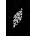 AN 18K WHITE GOLD AND DIAMOND BROOCH the Victorian design of scrolls and swirls, set with ten old