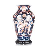 A JAPANESE IMARI VASE, 18TH/19TH CENTURY ovoid with a wide flaring neck, the body painted in typical