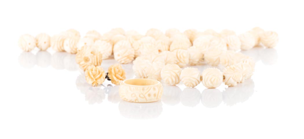 A HAND CARVED IVORY BEADS SET NOT SUITABLE FOR EXPORT comprising: a necklace, a bracelet, a pendant,